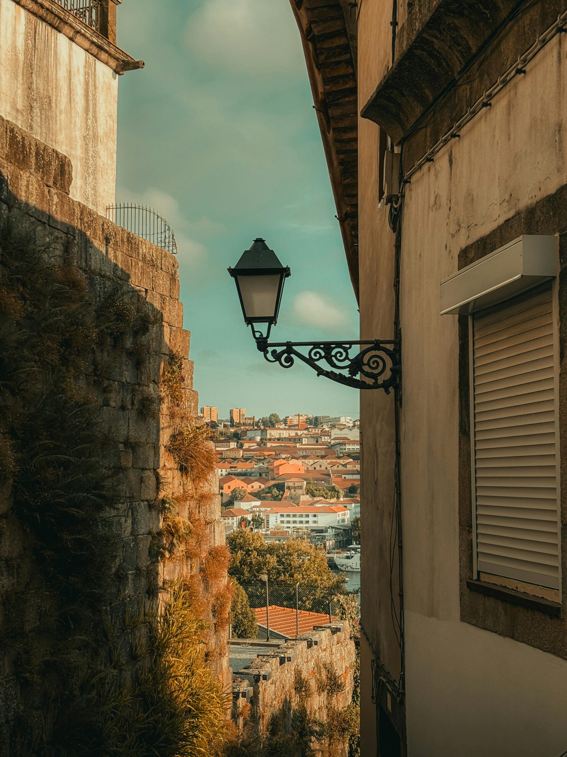 A picturesque alley in Porto, Portugal, showcasing historic architecture and a vibrant cityscape.